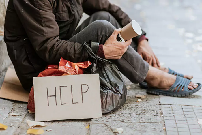 side view homeless man holding cup help sign n 652e609dd7503