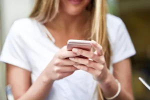 close up image young blonde girl texting with smartphone n 65ca02193ef65
