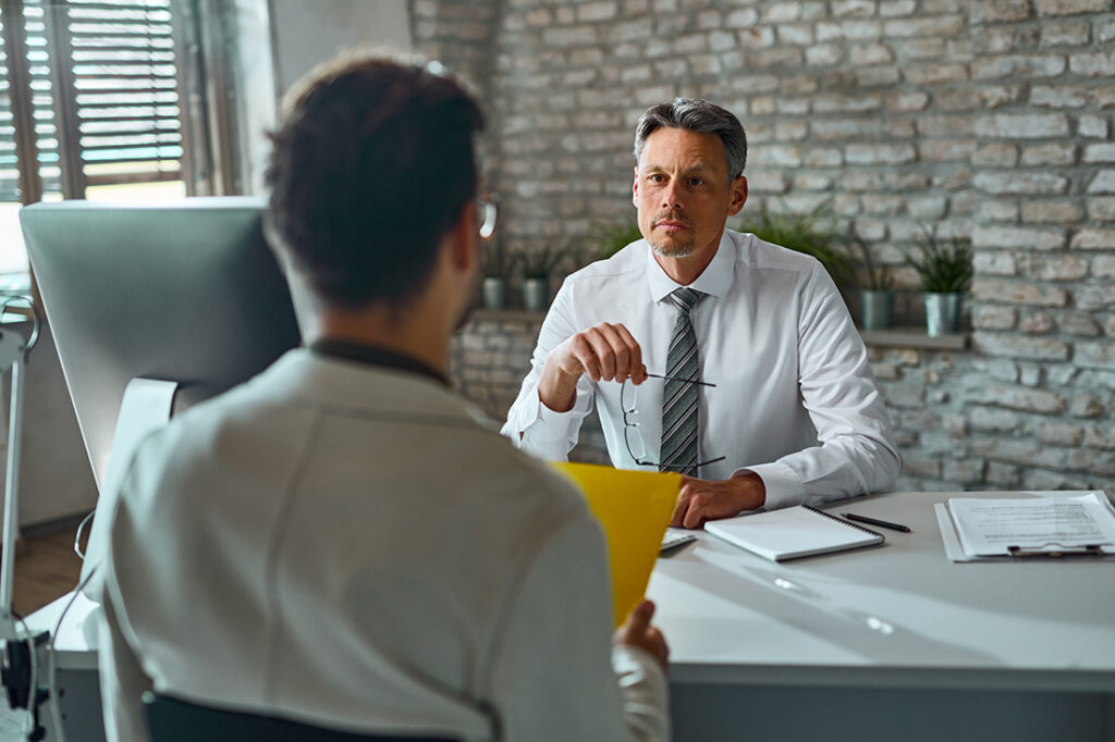 businessman talking to a candidate during job interview in the o