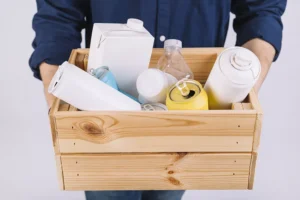 man s hand with wooden box full bottles tin cans 69b325f935873